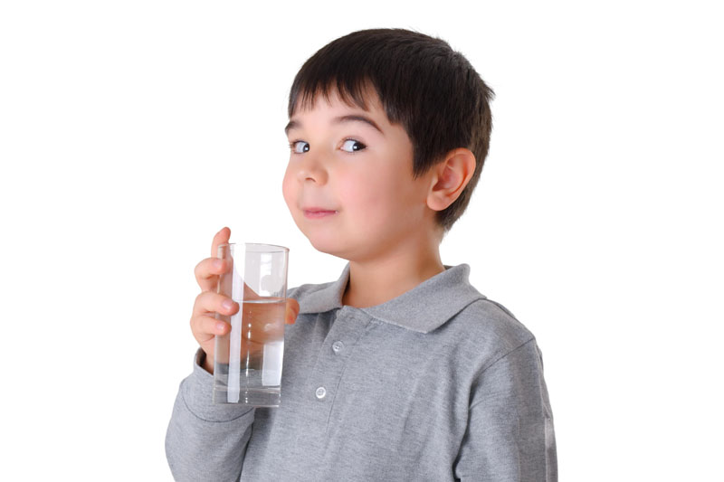 Boy drinking clean water from a pure source
